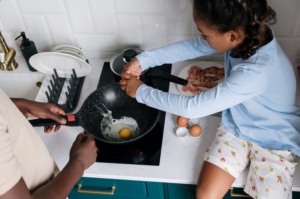 a girl frying egg